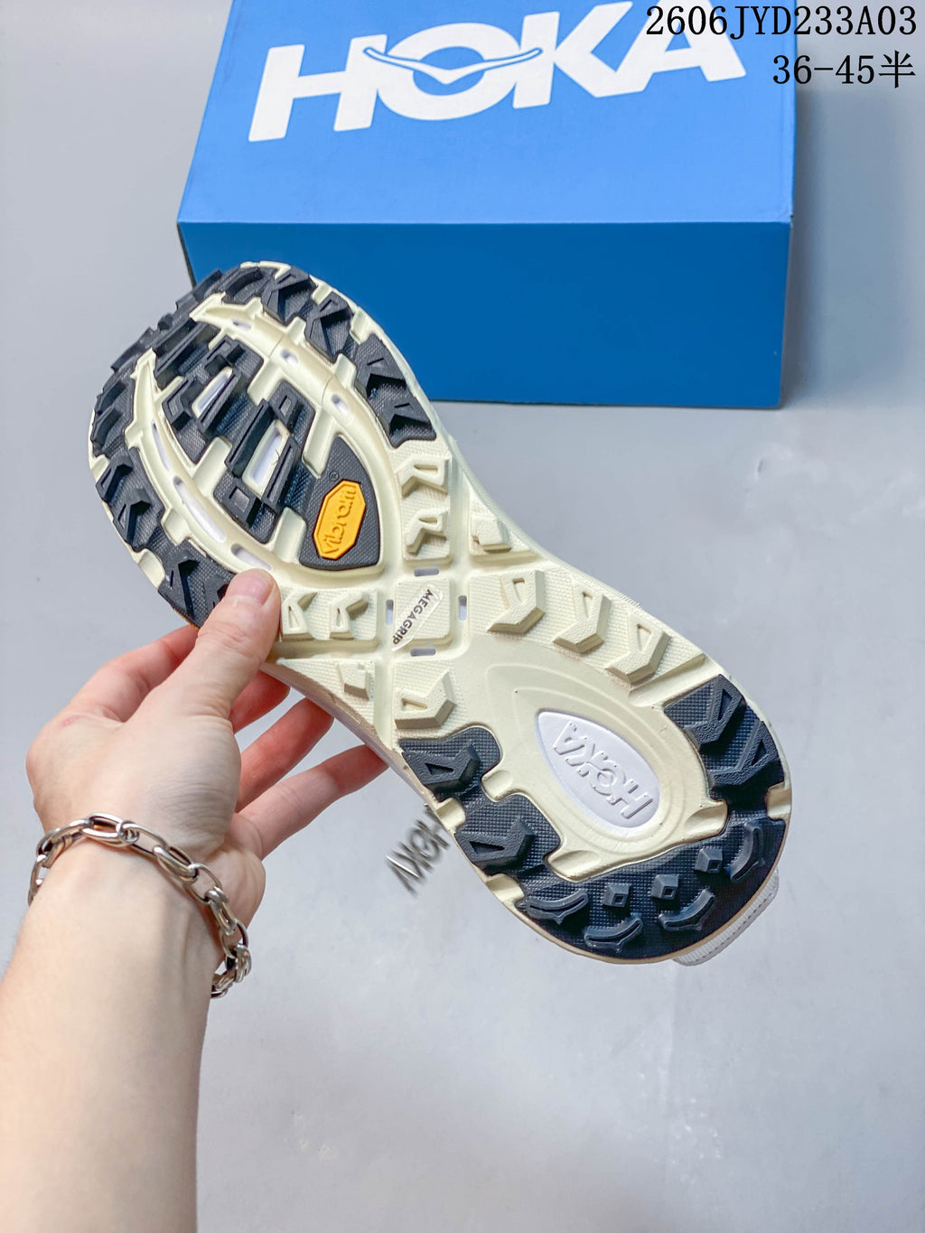 Close-up of the rugged patterned outsole on a HOKA trail shoe
