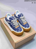Pair of blue patterned low-top sneakers with white laces and gum-colored soles