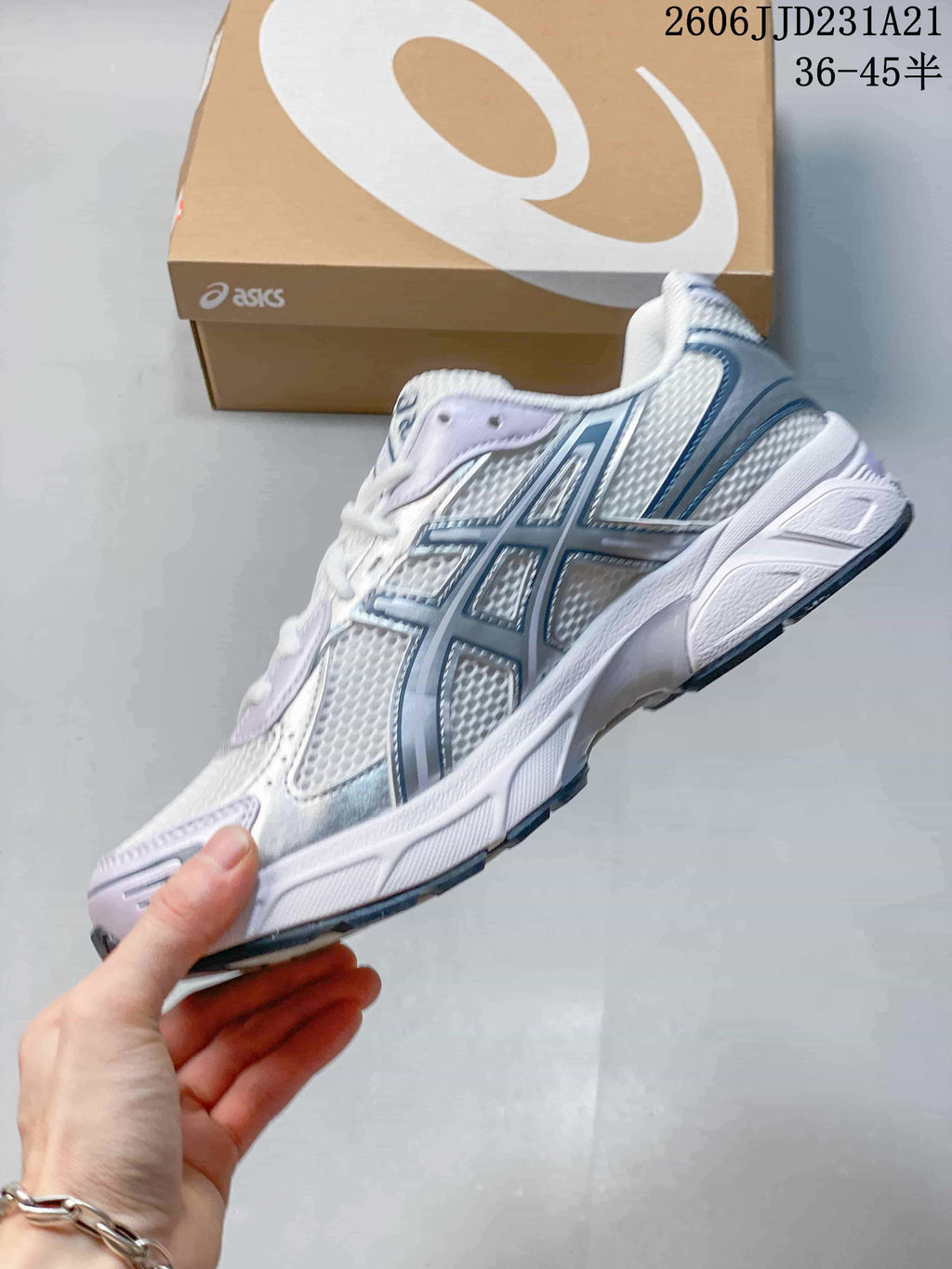 Side view of a white ASICS GEL-1130 sneaker with silver and lavender accents