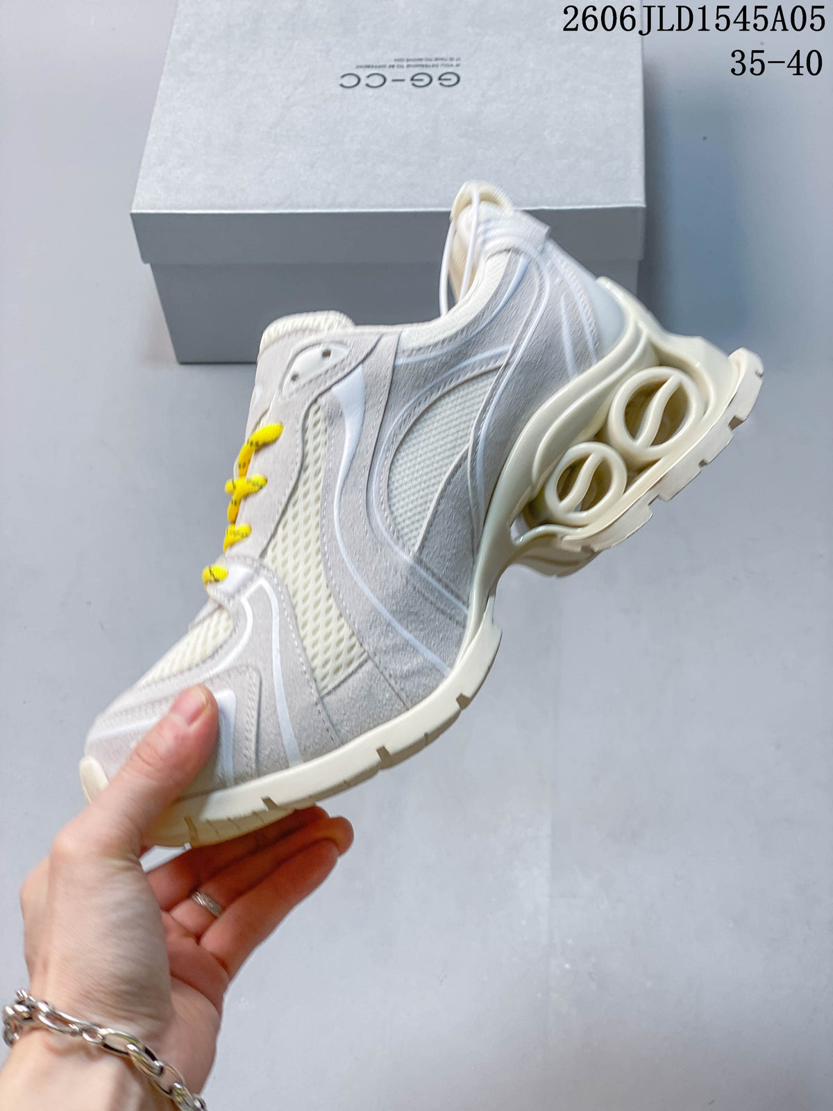 Side view showing layered panels, mesh sections, yellow laces, and a sculpted sole