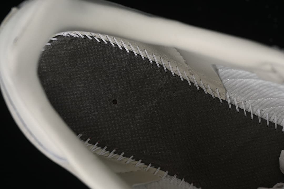 Close-up view inside the sneaker showing the insole and stitched inner construction
