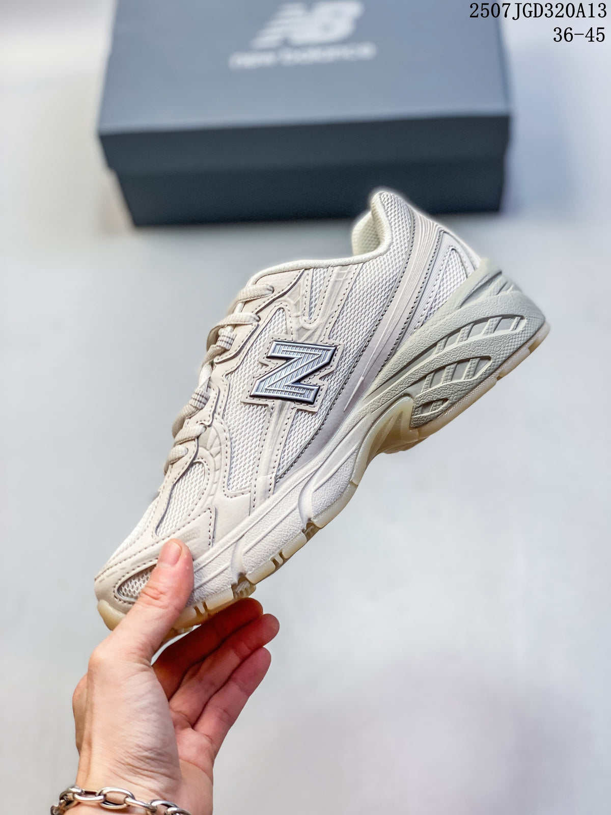 Side profile of a light neutral New Balance 740 sneaker