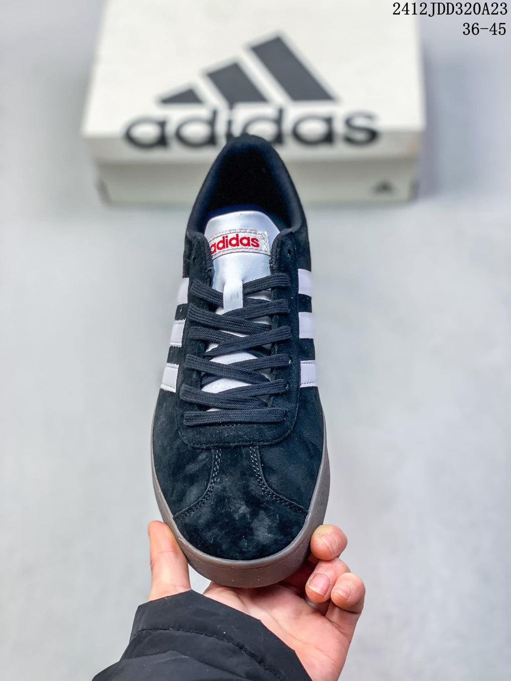 Front view of a black Adidas VL Court Classic lace-up sneaker with white stripes