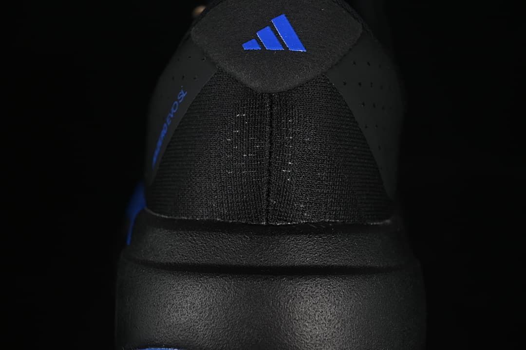 Rear view of the black shoe with blue Adidas heel branding.