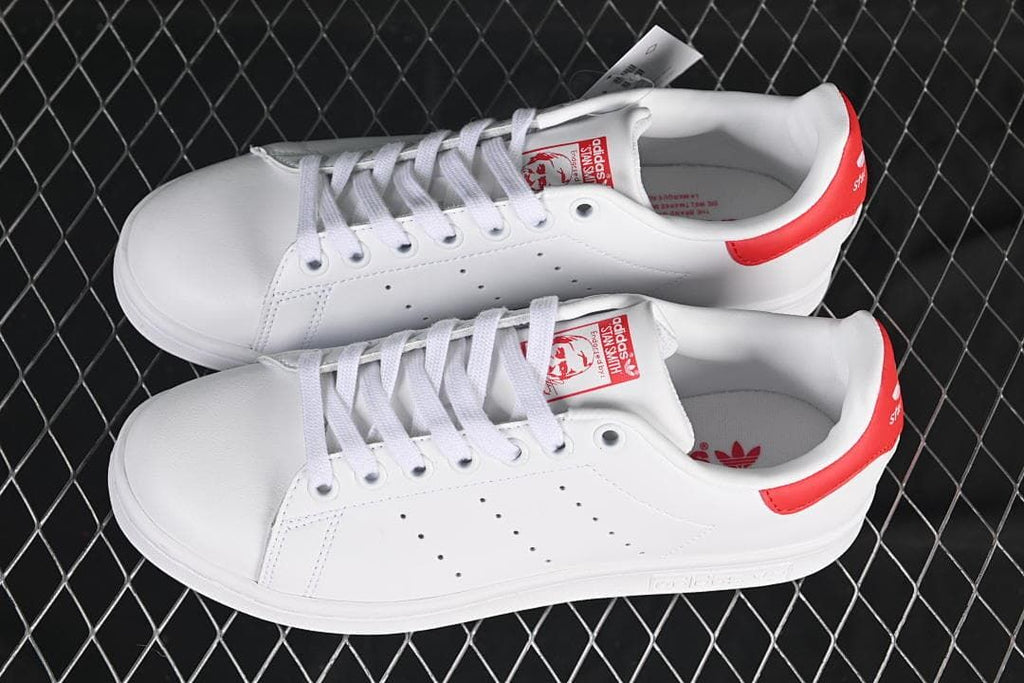 Pair of white and red Stan Smith sneakers viewed from above