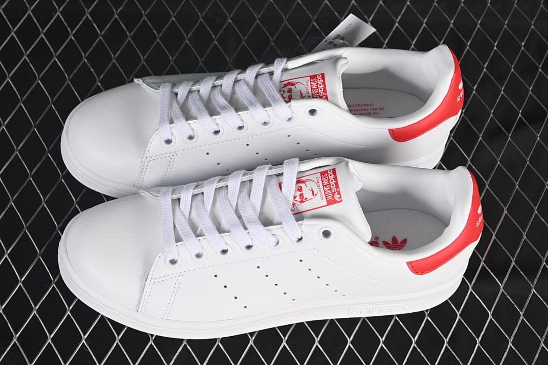 Pair of white and red Stan Smith sneakers viewed from above