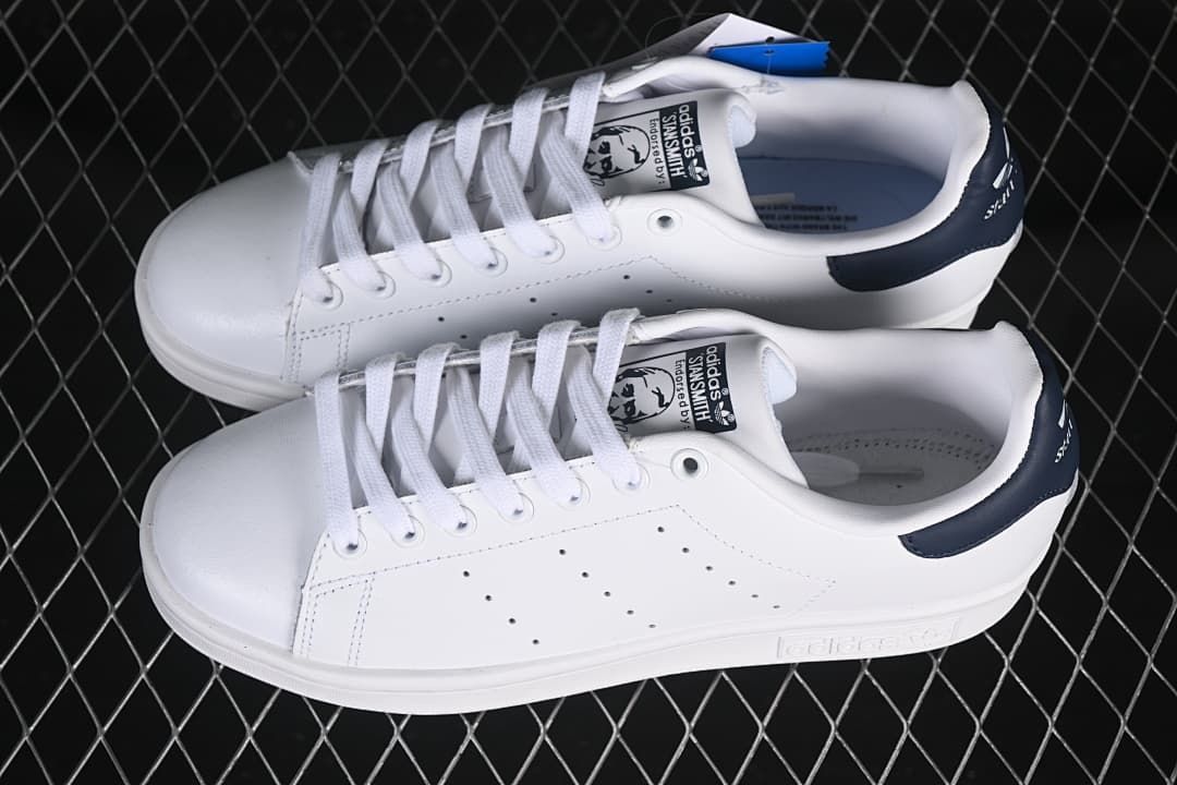Pair of white Stan Smith sneakers with navy heel tabs.