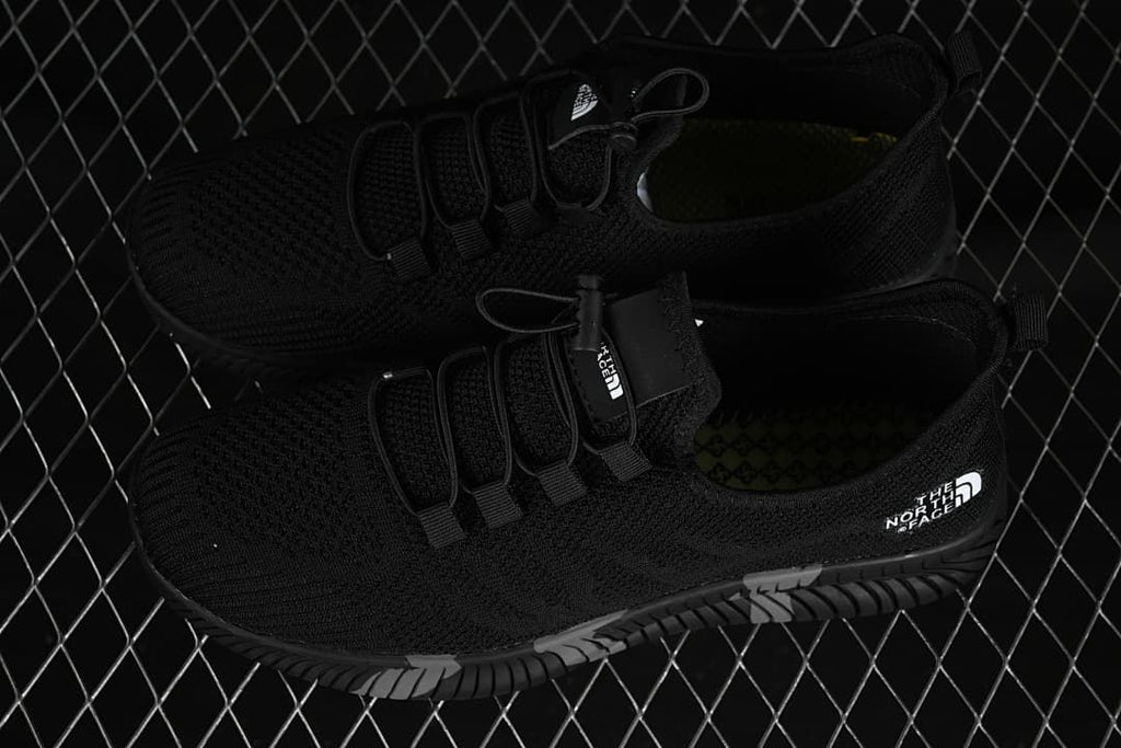 Pair of black sneakers shown from above and at an angle