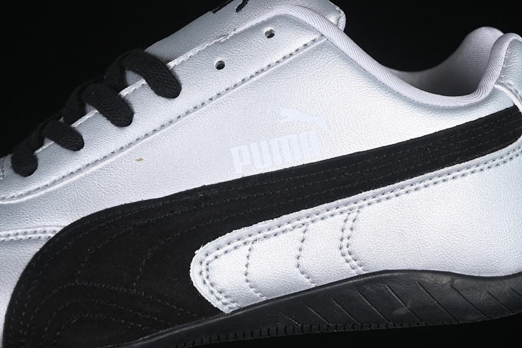Close-up of the black side stripe, silver upper and stitched panels.