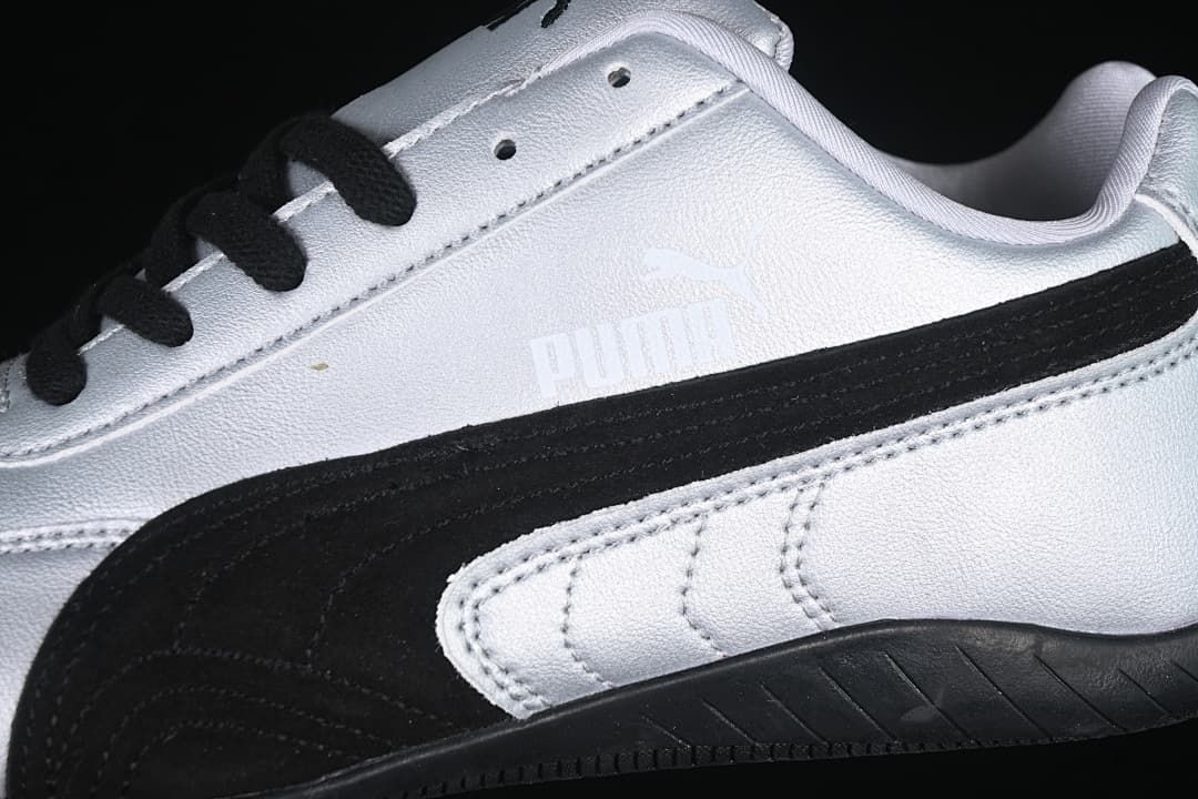 Close-up of the black side stripe, silver upper and stitched panels.
