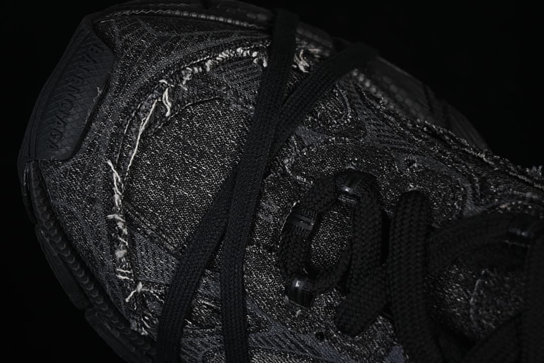 Angled close-up of the textured upper, stitching, and lace loops.