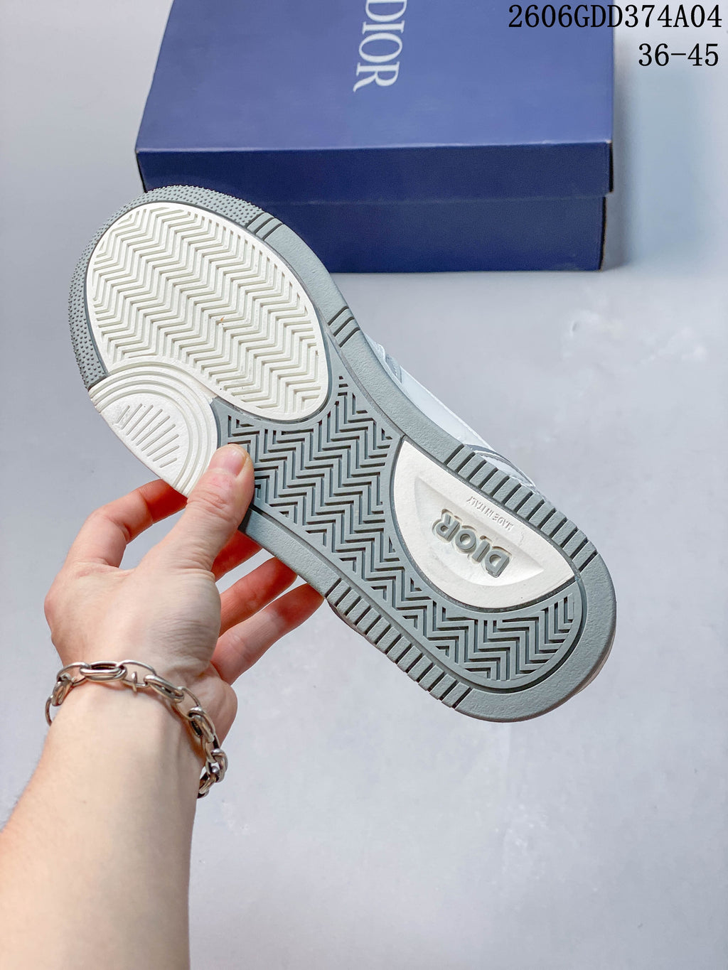 Underside of the sneaker showing a patterned, textured outsole