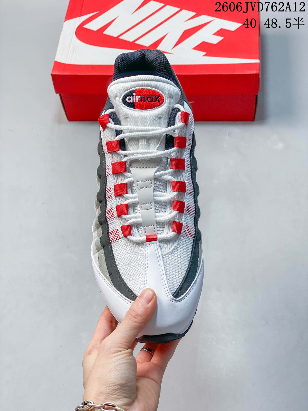 Top view of a Nike Air Max 95 OG sneaker showing white laces, red lace loops, and a mesh-patterned upper.
