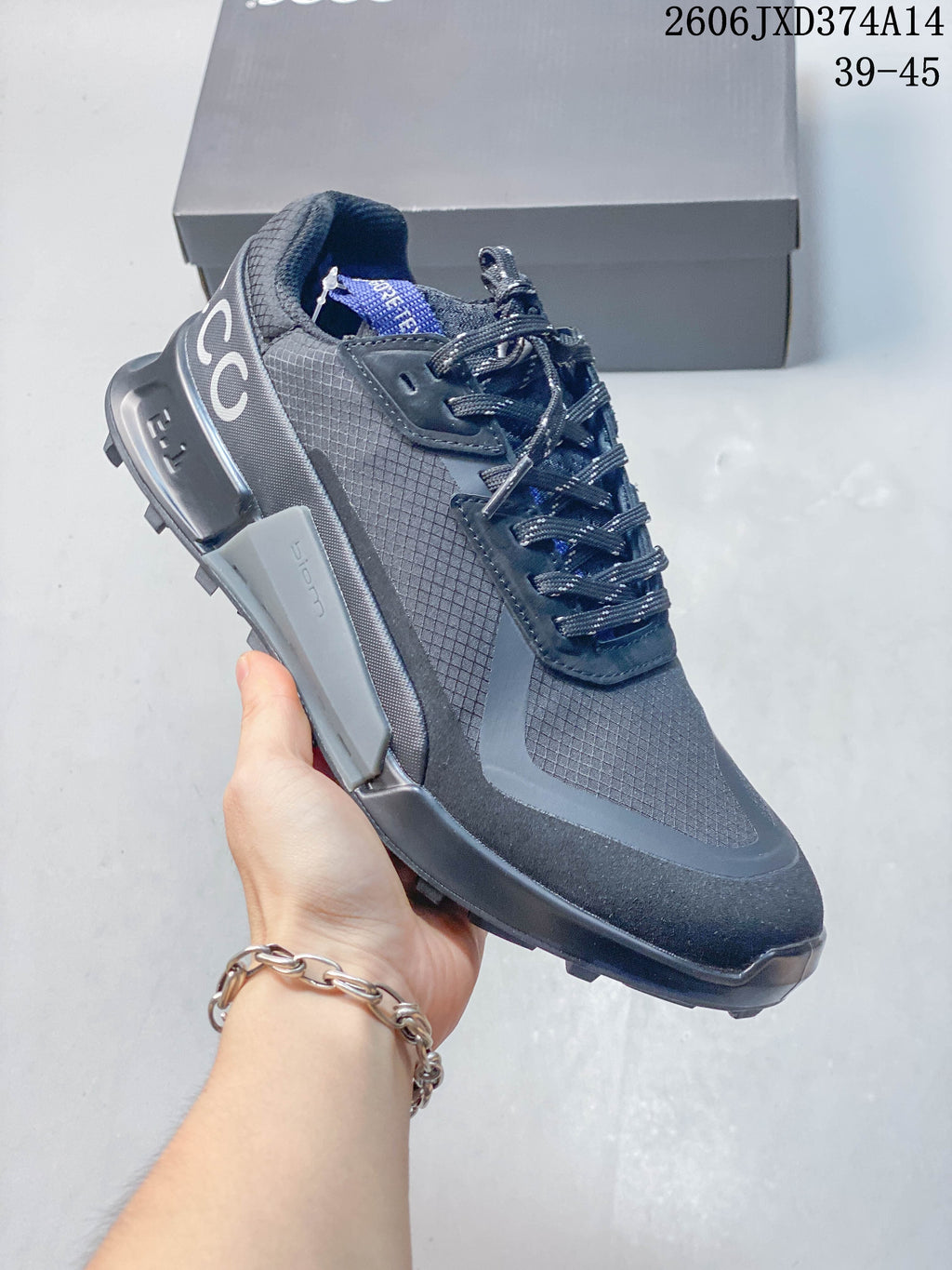 Side view of a gray lace-up ECCO sneaker with a rugged outsole