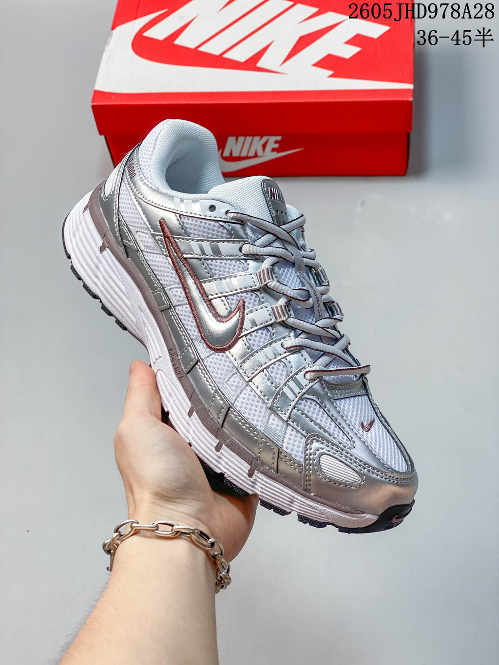 Angled side view of the silver Nike Initiator running shoe