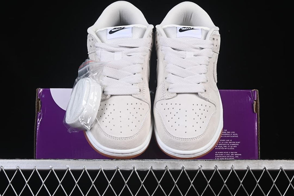 Front view of the pair with an extra set of laces beside the shoes