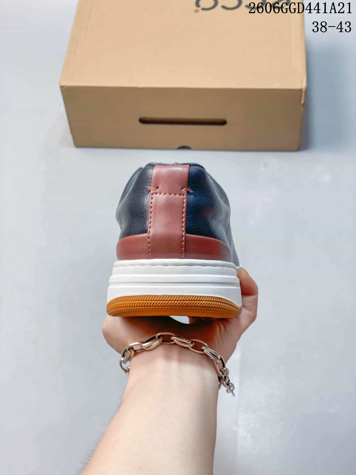 Rear view of a sneaker showing brown heel accents, a white midsole and a brown outsole.
