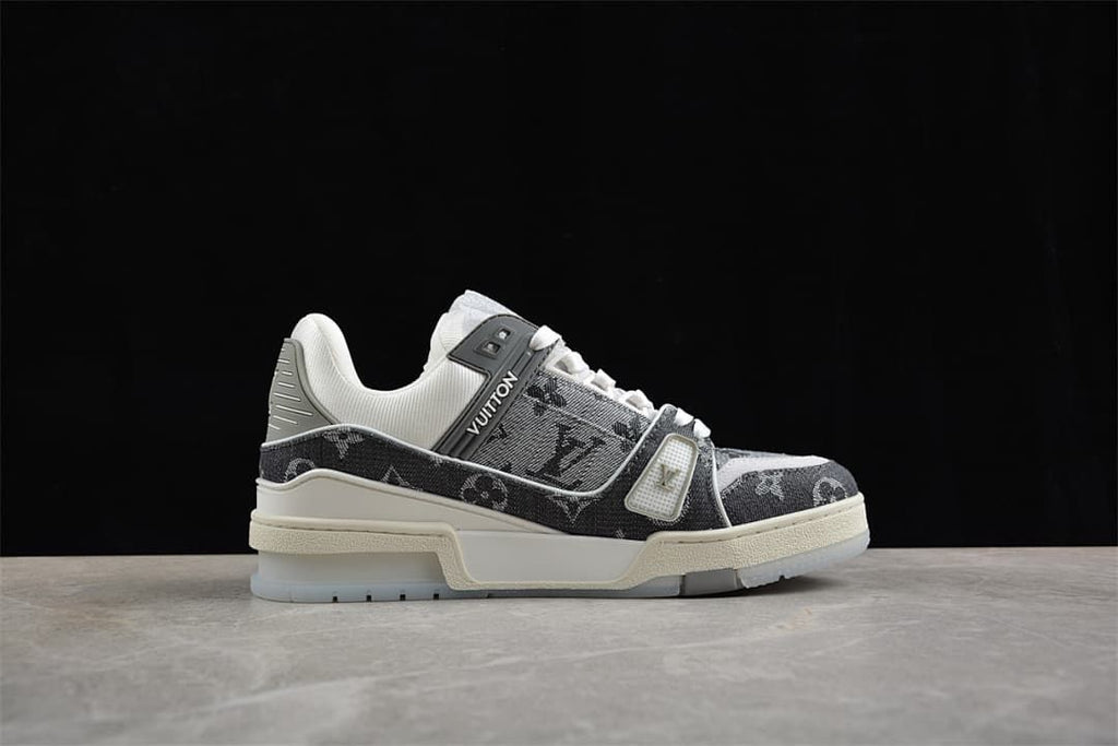 Side profile of a gray patterned sneaker with white laces and a cream-colored sole.