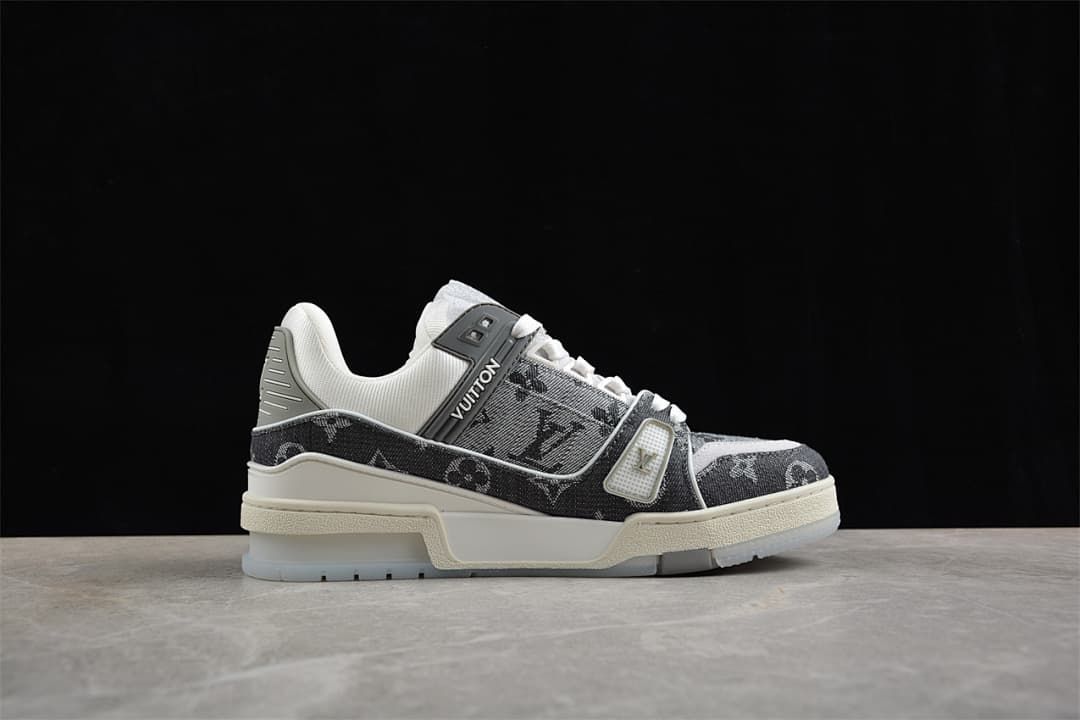 Side profile of a gray patterned sneaker with white laces and a cream-colored sole.