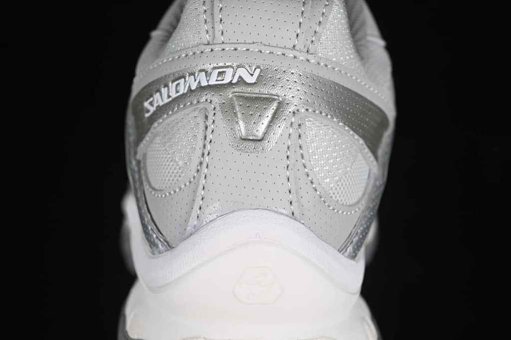 Rear close-up of the sneaker with Salomon branding and layered heel details.