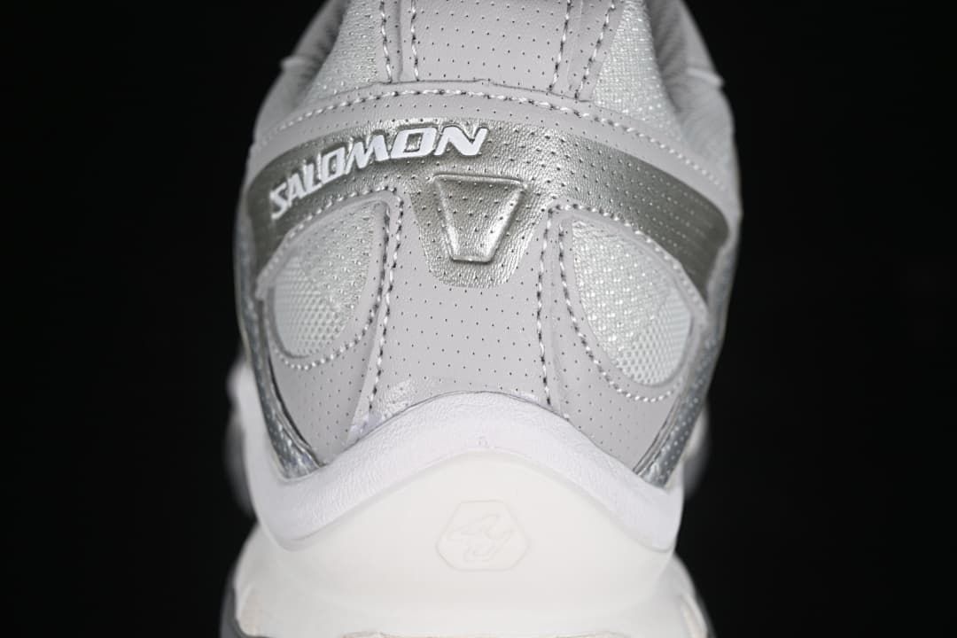 Rear close-up of the sneaker with Salomon branding and layered heel details.
