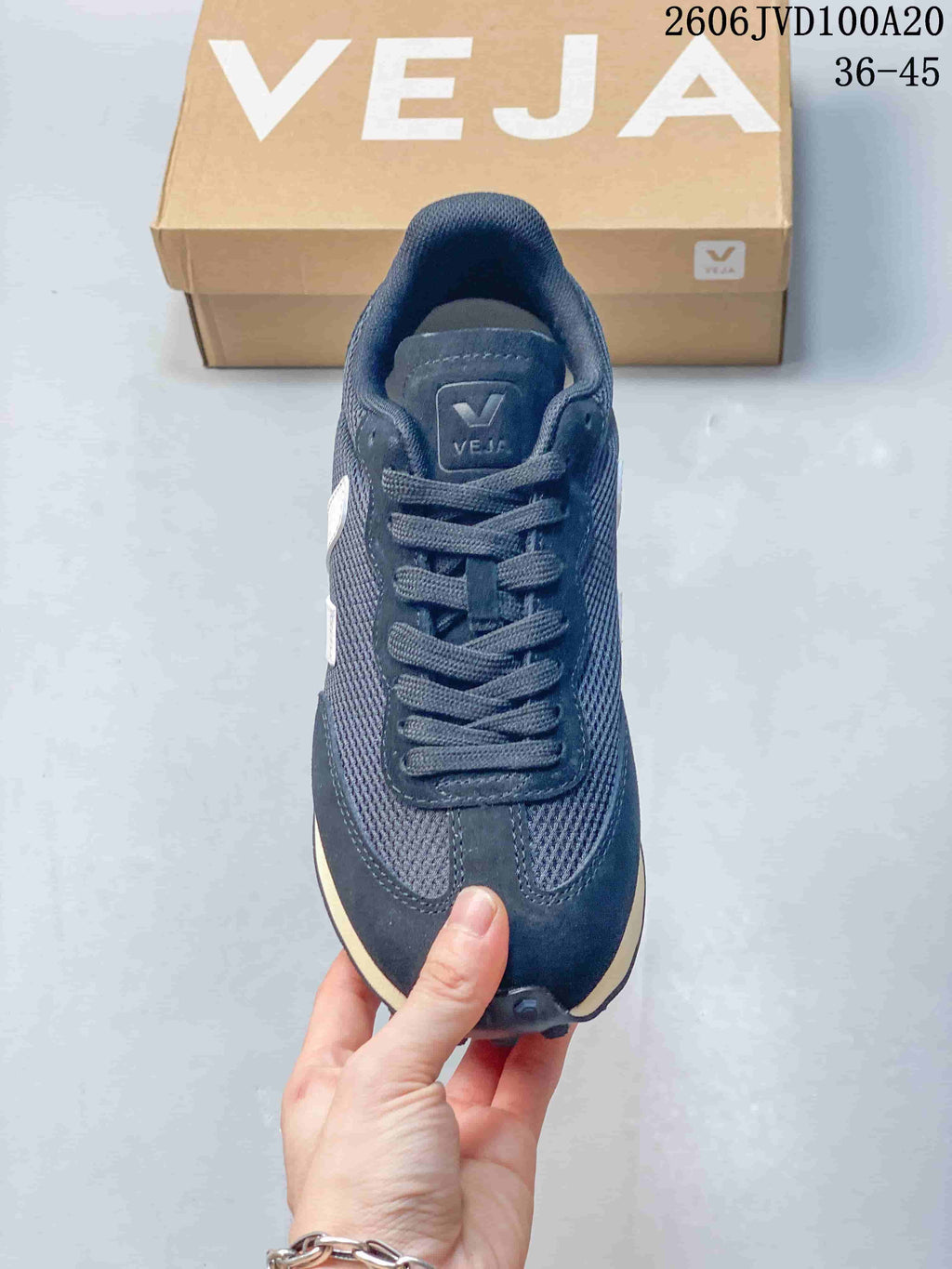 Top view of a navy Veja lace-up sneaker with a white side logo.