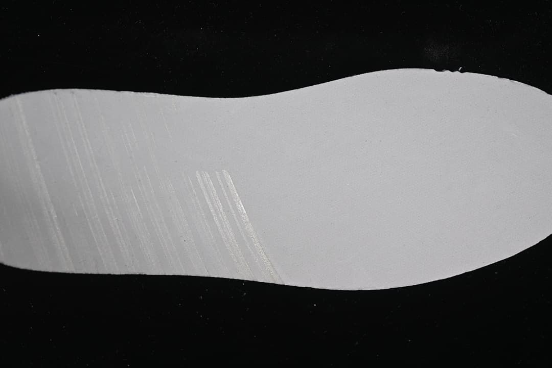 Close-up view of a light-colored sneaker outsole