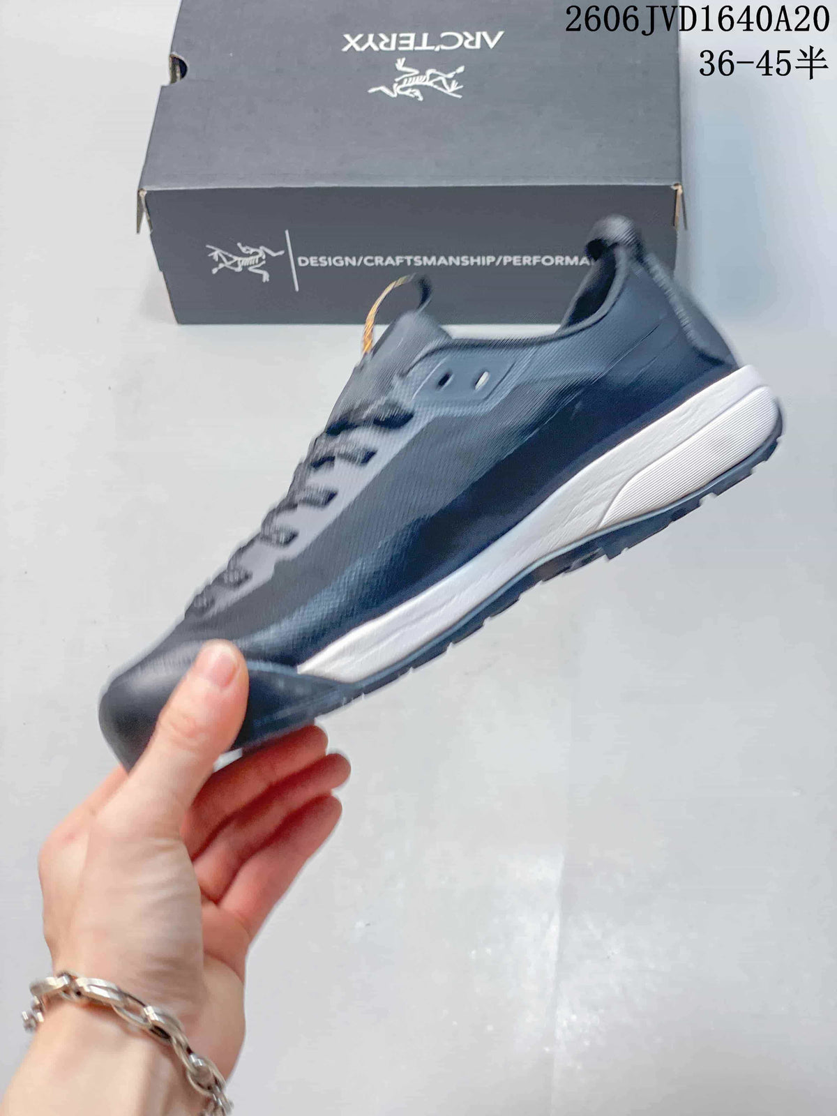 Side view of the gray Konseal LT trail shoe with lace-up closure