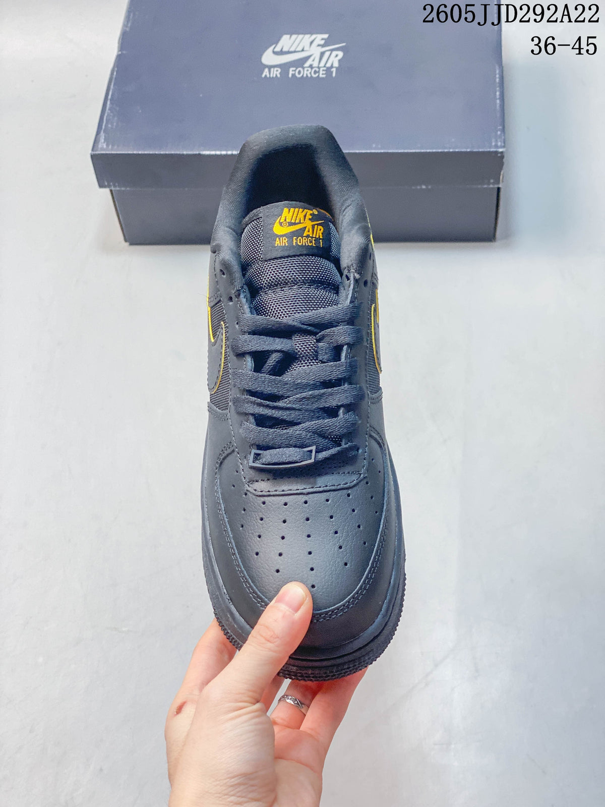 Top view of a gray Nike sneaker showing its laces and perforated toe