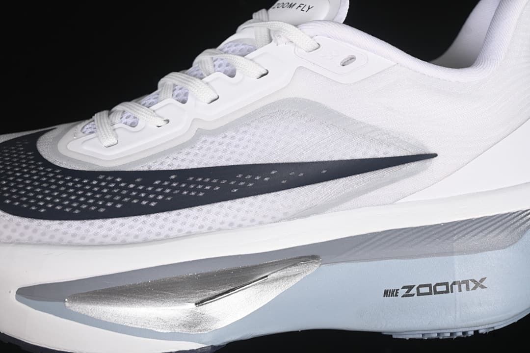 Side detail showing the dark Swoosh, mesh-like upper appearance, and midsole.