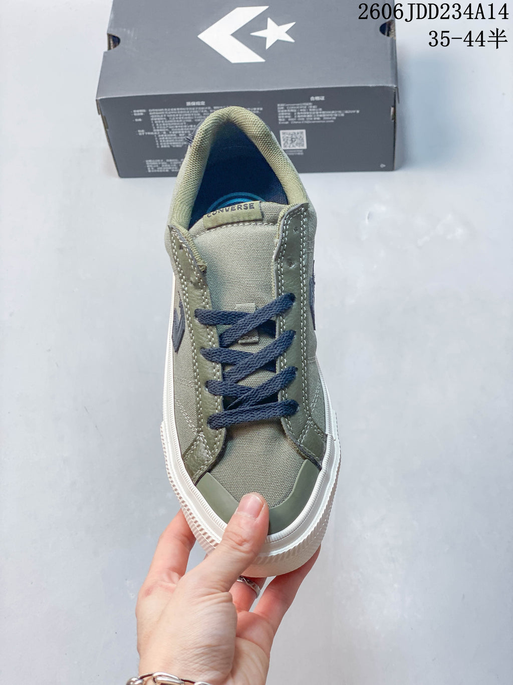 Top view of the olive sneaker showing navy laces and contrast toe detail