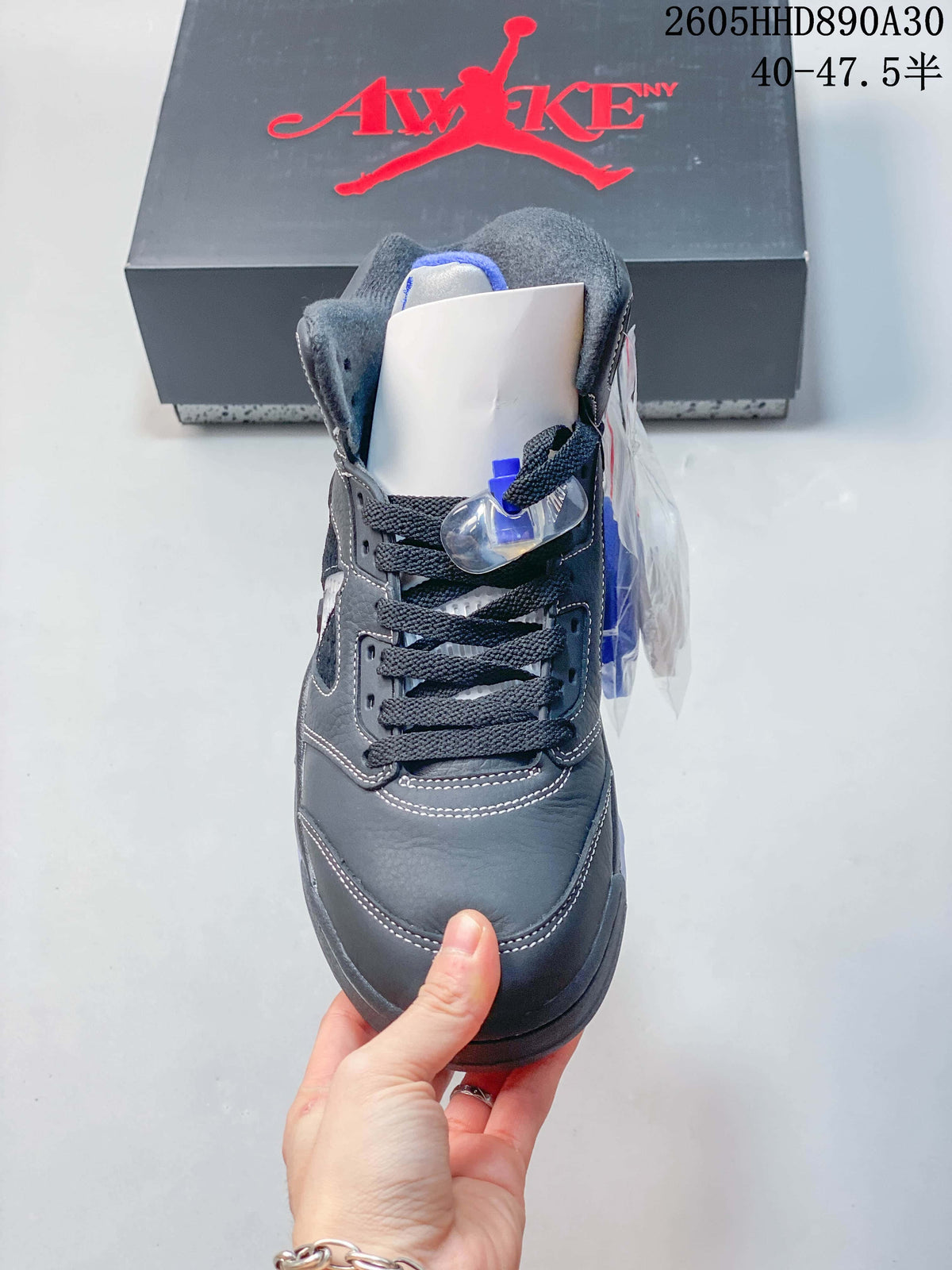 Front view of the gray and blue Air Jordan 5 high-top sneaker