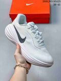 White Nike Pegasus-style running shoe with a dark side Swoosh and sculpted white midsole.