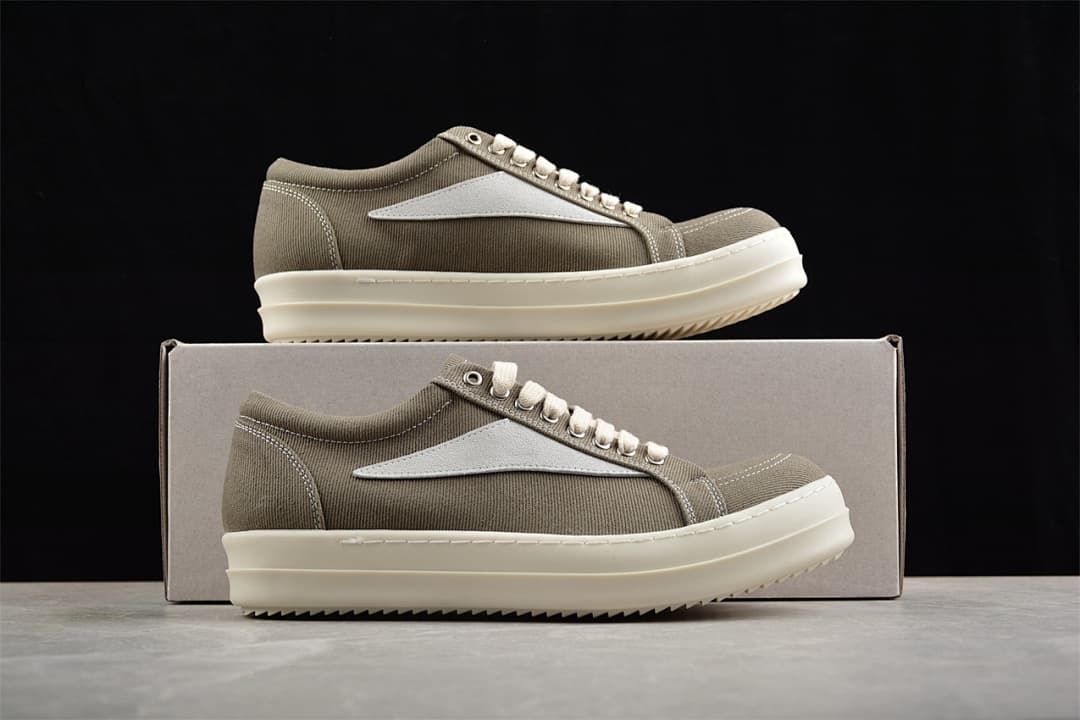 Two brown canvas sneakers displayed against a shoe box