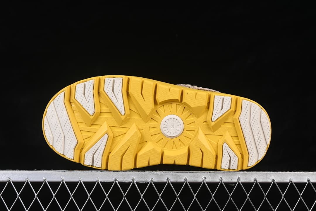 Underside view showing the yellow tread with light-colored sections