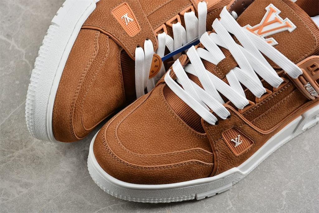 Close-up view of the brown sneaker toe, side panels and white laces