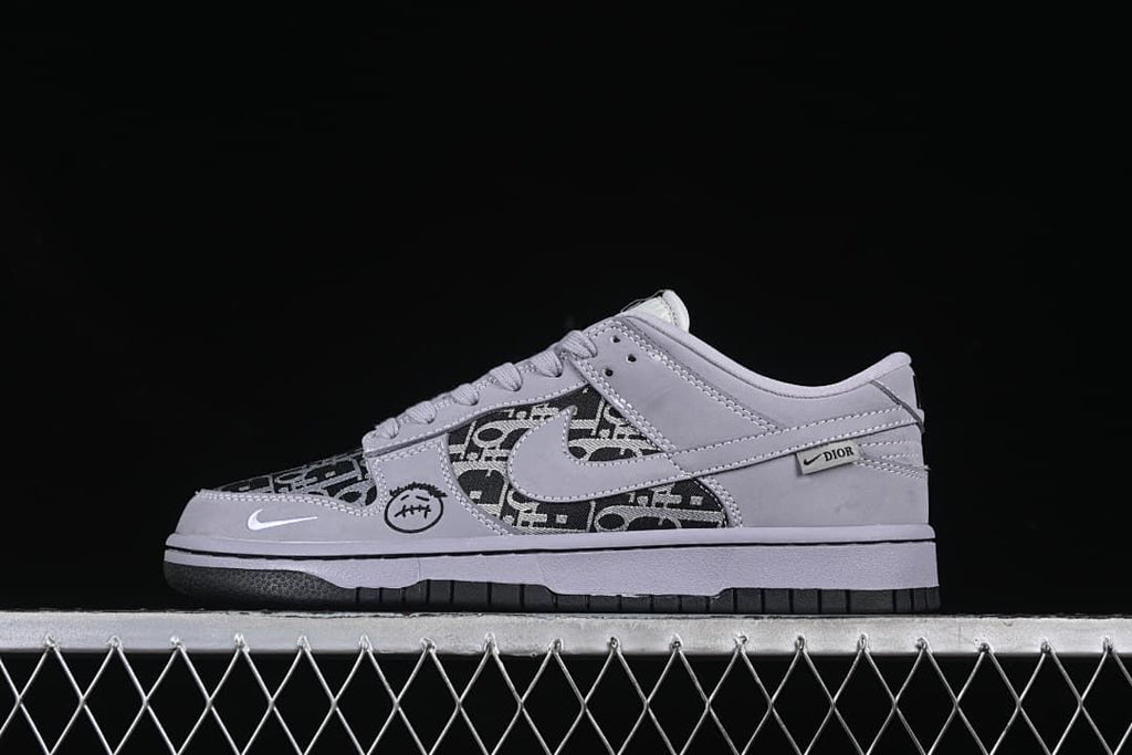 Side view of a gray and black patterned low-top sneaker with contrasting dark outsole
