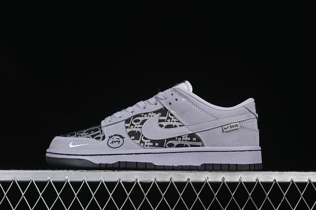 Side view of a gray and black patterned low-top sneaker with contrasting dark outsole