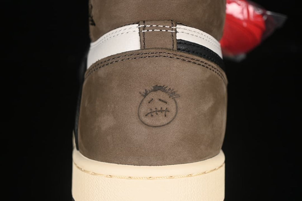 Close-up of a circular face motif on the brown heel panel