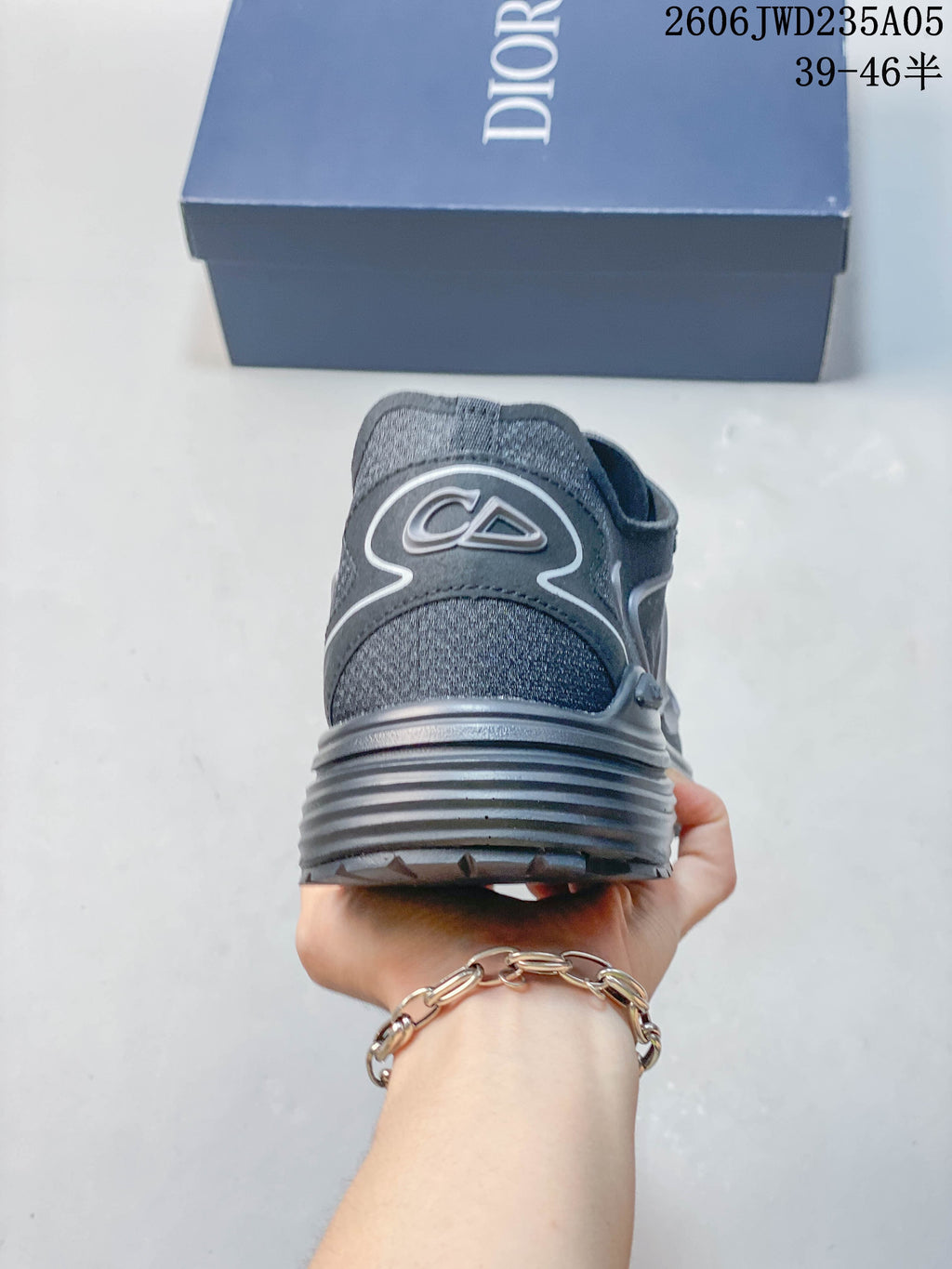 Rear view of a grey Dior B30 sneaker with a chunky, ridged heel sole.