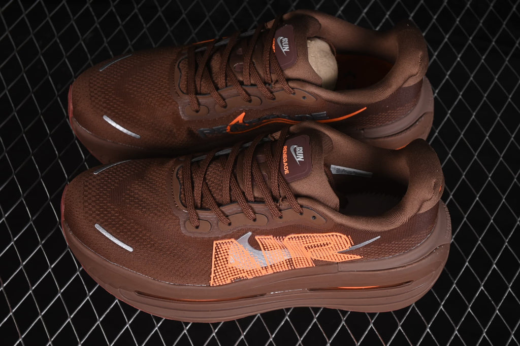 Pair of brown Nike sneakers with orange side graphics, brown laces, padded collars, and reflective toe details.