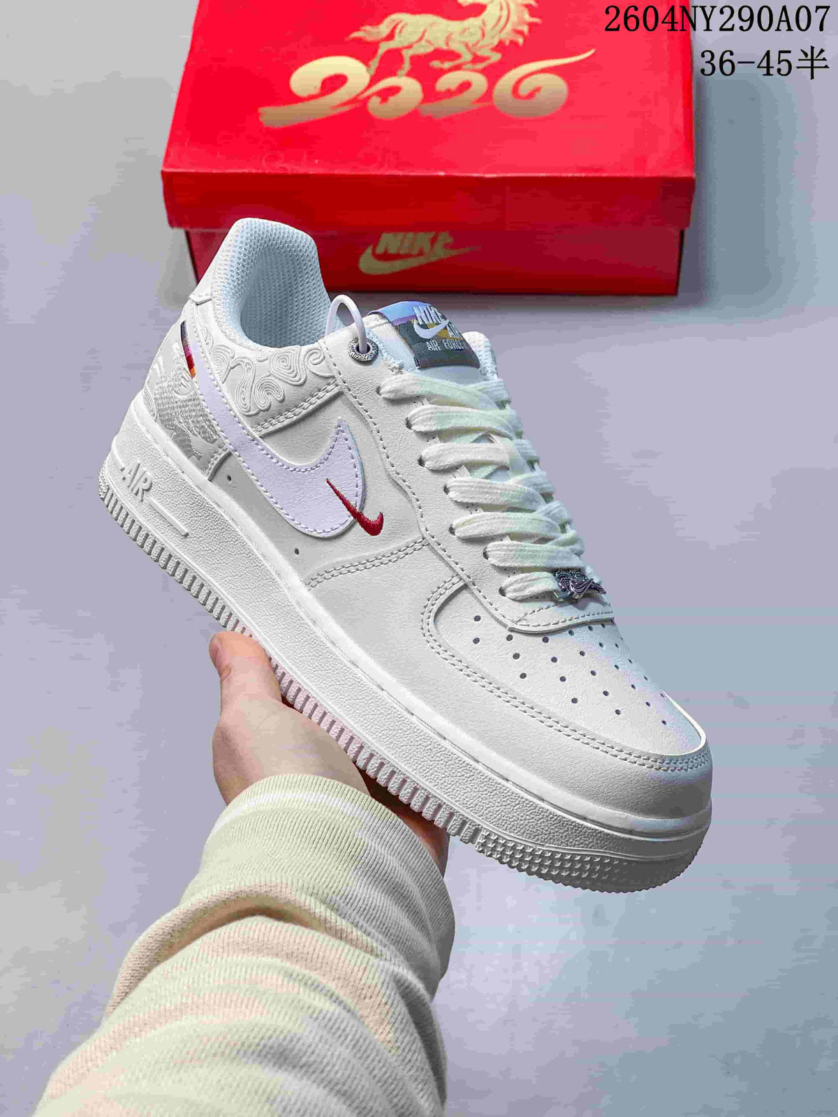 Close-up of a white low-top sneaker with embroidered side details and contrasting swoosh.