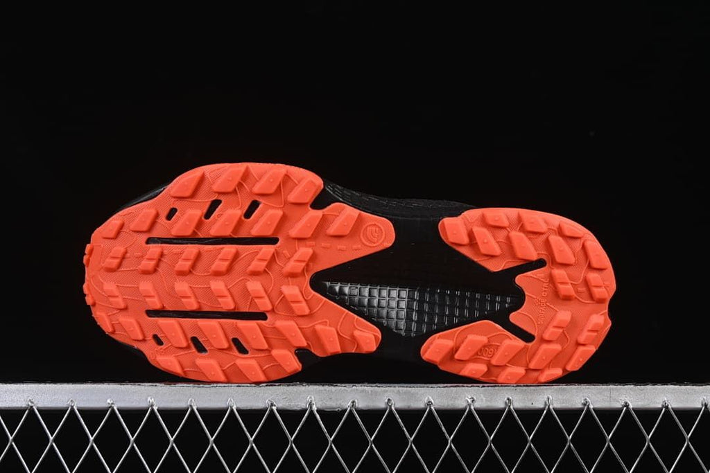 Underside view showing the orange tread and black midfoot section.