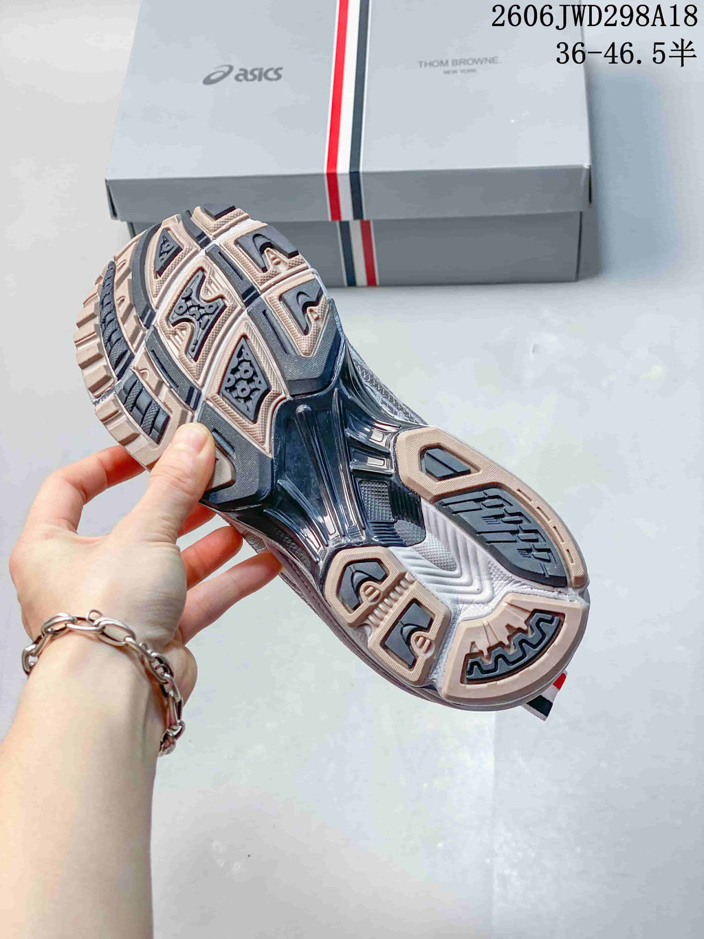 Underside of the sneaker showing a segmented patterned outsole.