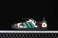 Side view of adidas Samba LT JS3930 sneakers with brown-and-white cow print, green stripes and black sole