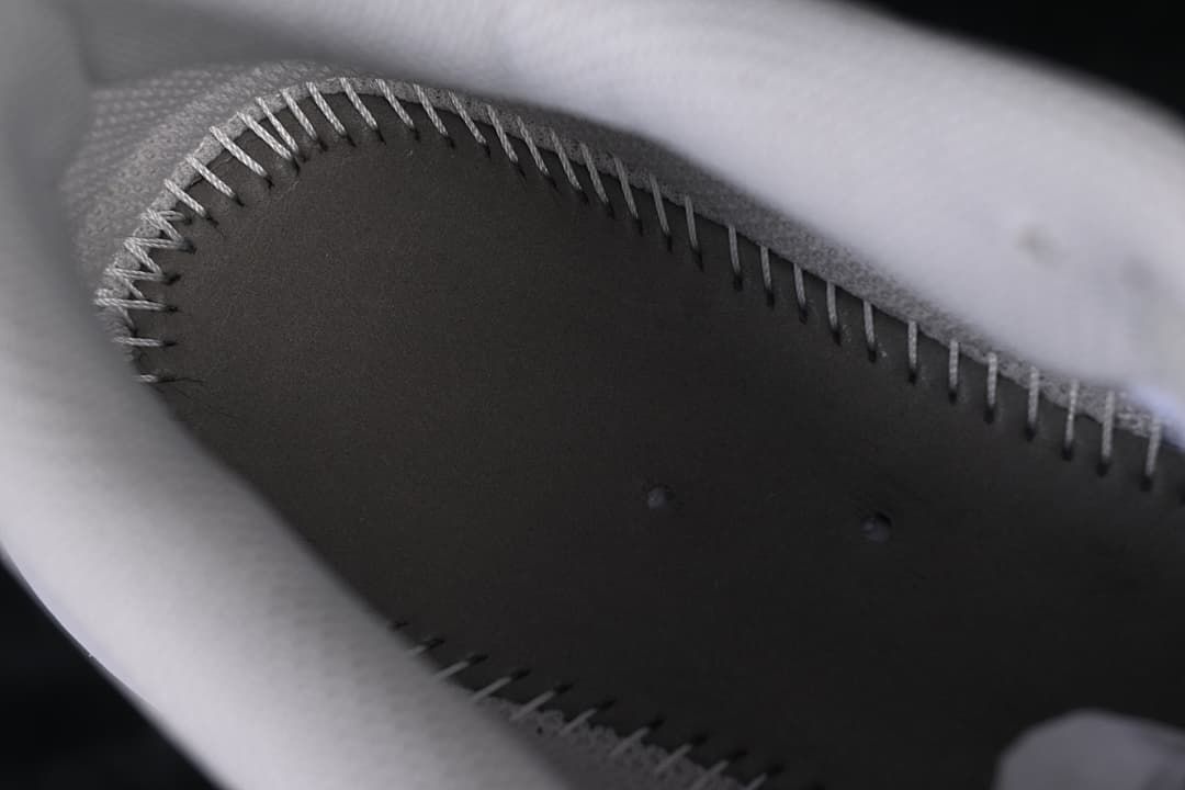 Close-up inside the shoe showing stitched insole edging.