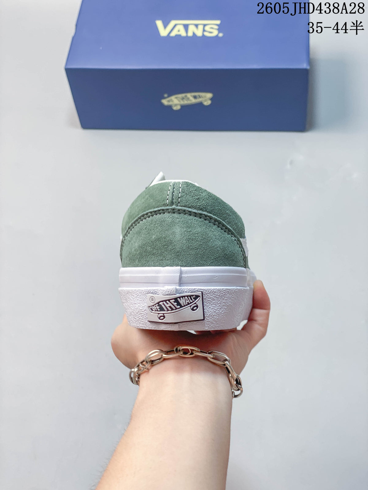 Rear view of the green sneaker showing the heel and white sole