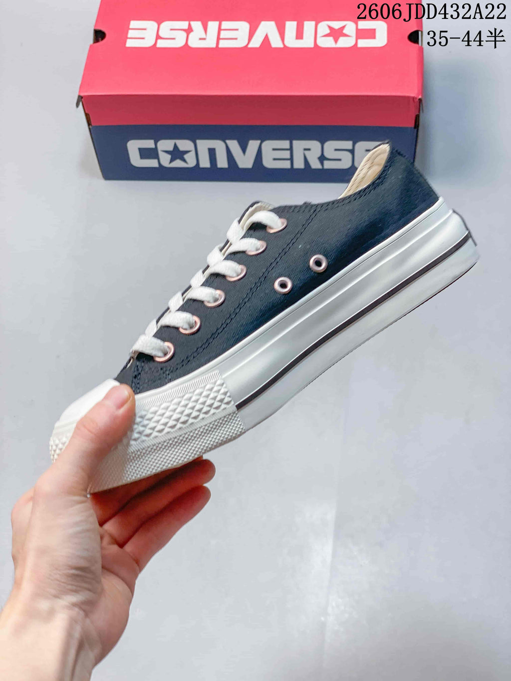 Side view of a navy Converse All Star low-top sneaker with white sole and laces