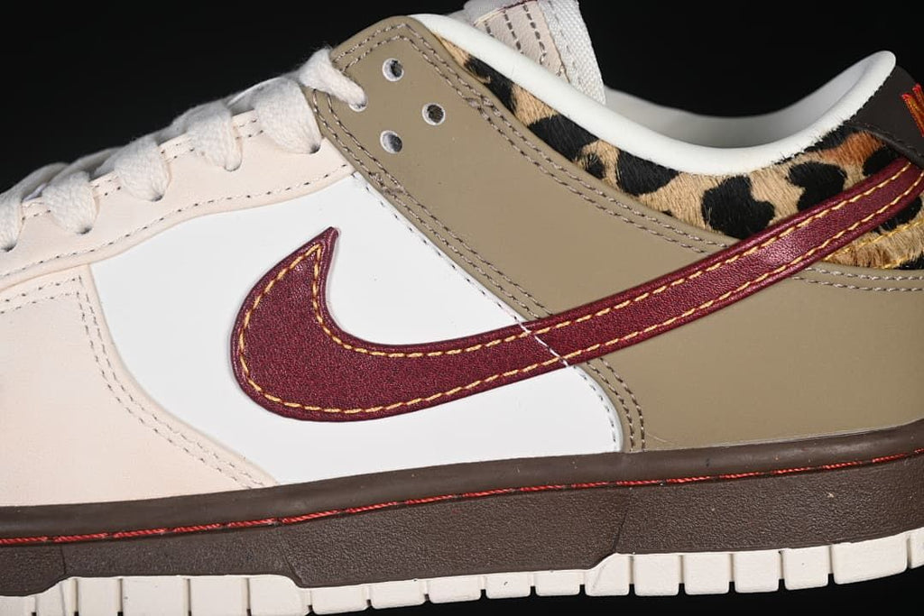 Close-up of the burgundy side Swoosh and contrasting sneaker panels