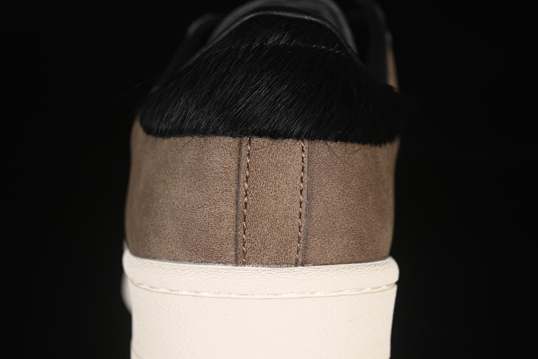 Rear view showing brown heel panels and black heel details